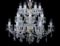 The chandelier has glass arms in two levels