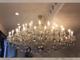 Large Theresian chandelier 63 light bulbs in a low interior