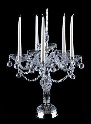 large crystal candlestick on a table made of silver metal and crystal glass